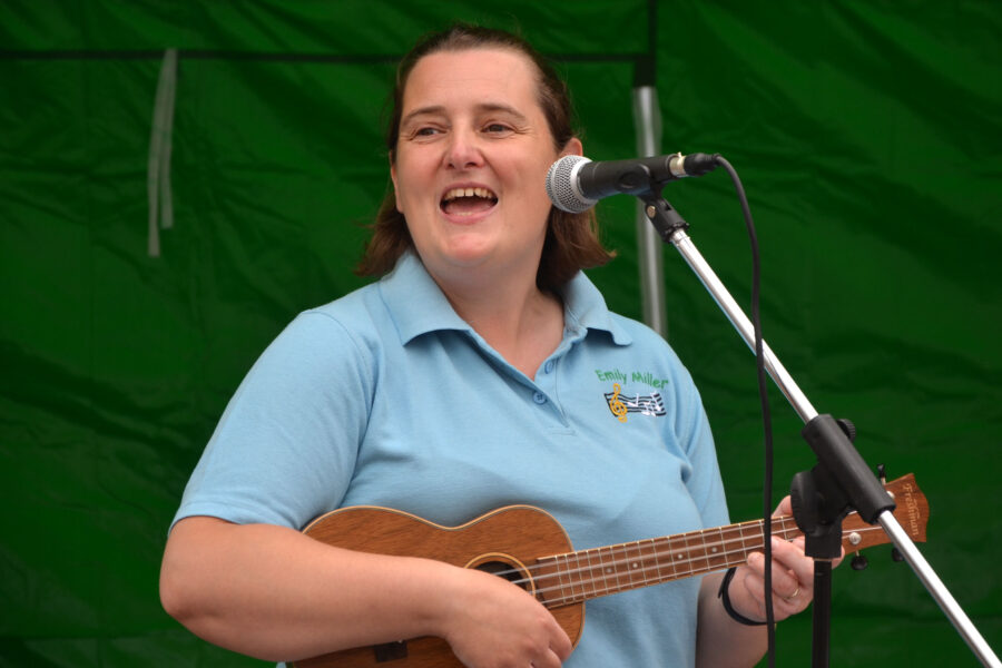 Emily Miller performing at New Street Corner on Honiton Market Charter Day 2025