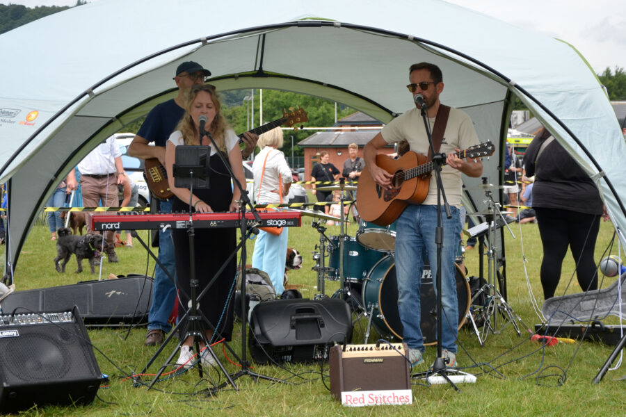 Red Stitches playing on Allhallows Playing Field at Honiton Market Charter Day 2025