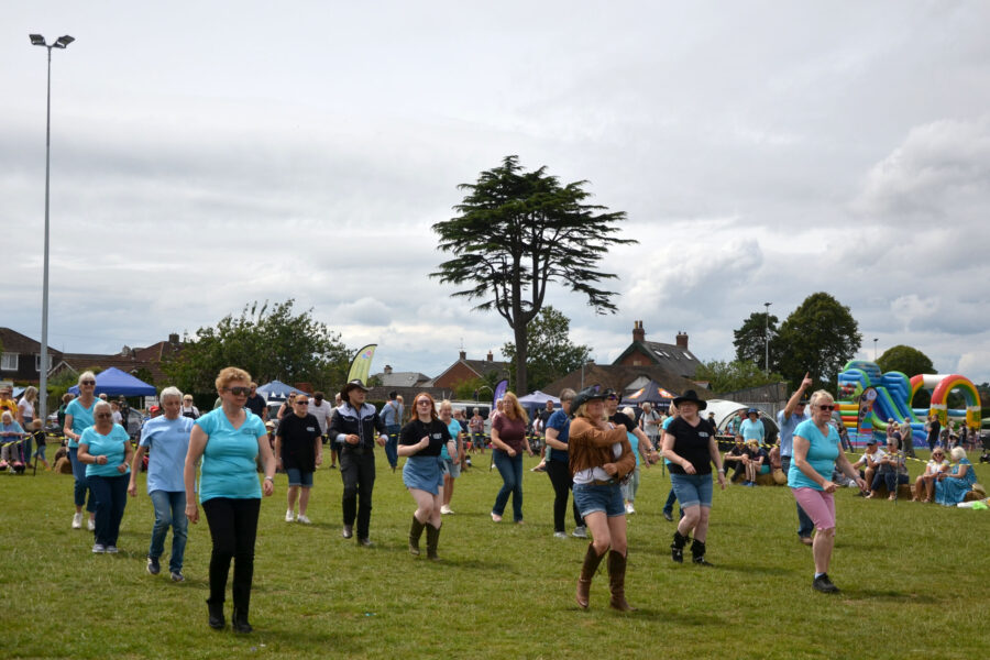 Western Spirit Line Dance Club performing on Allhallows Field at Honiton Market Charter Day 2025.